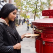 An image of a person putting their results in a mail box