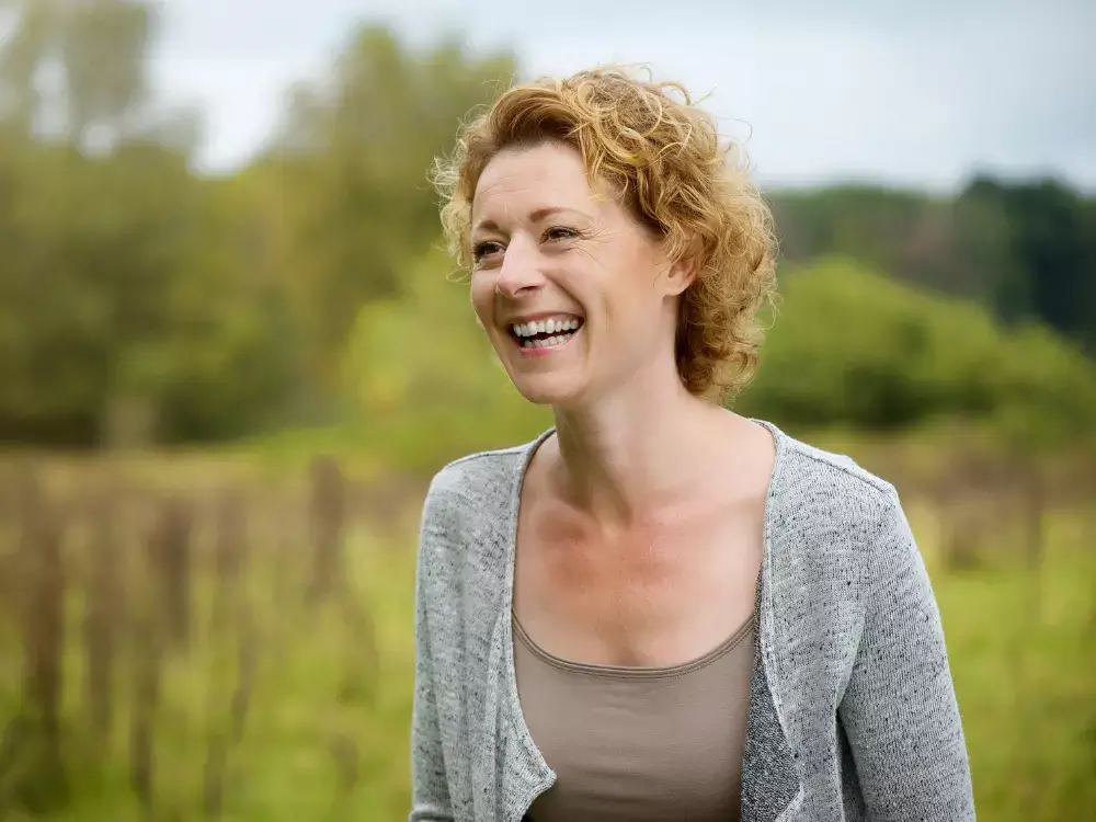 Close up portrait of a smiling middle aged woman outdoors